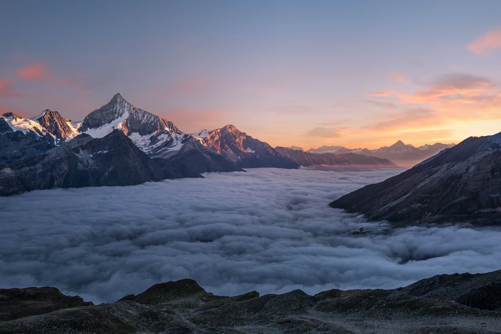 Golden sunset glow over mountain ranges